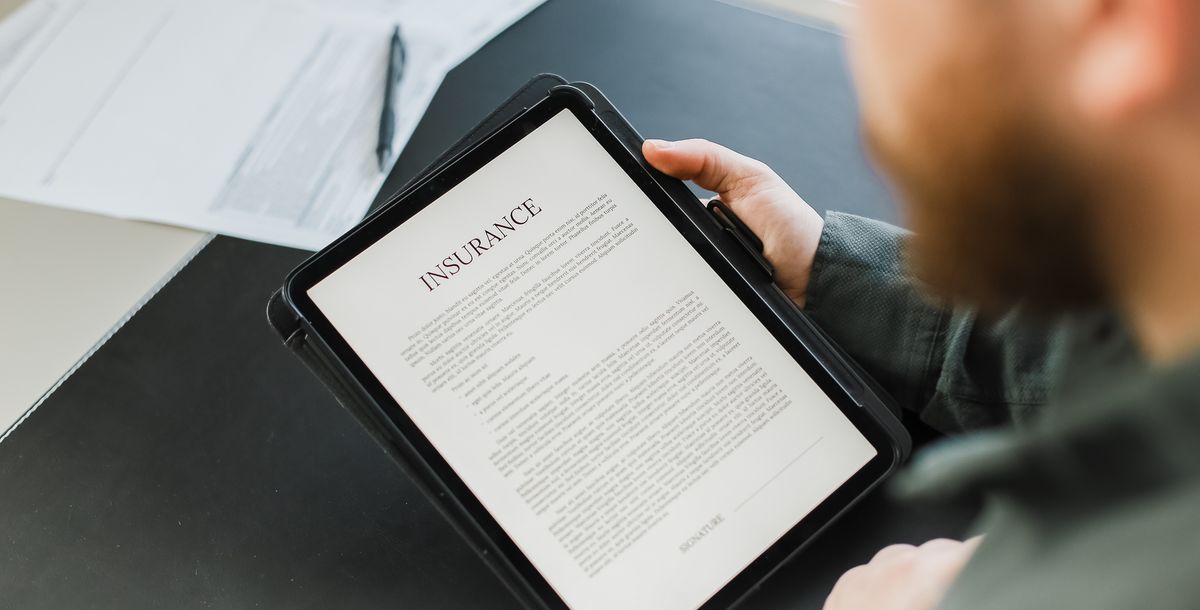 A person reviews insurance coverage on a tablet.