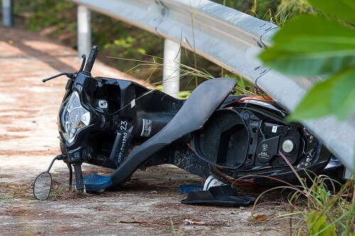 A bike lays in the road after a motorcycle accident.