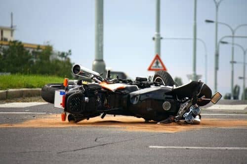 A motorcycle in the road after a motorcycle accident.