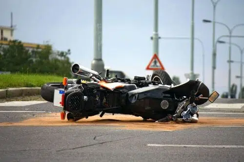 A motorcycle in the road after a motorcycle accident.