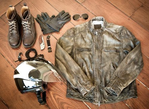 Motorcycle safety gear including a jacket, gloves, helmet, and boots.