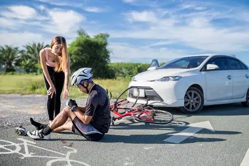 A man and a woman discuss what to do after a bicycle accident in North Carolina. 