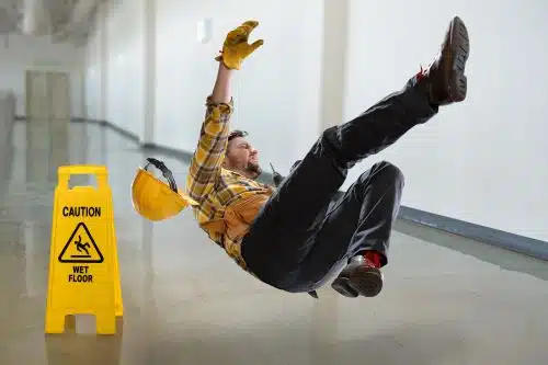 A construction worker slips and falls.