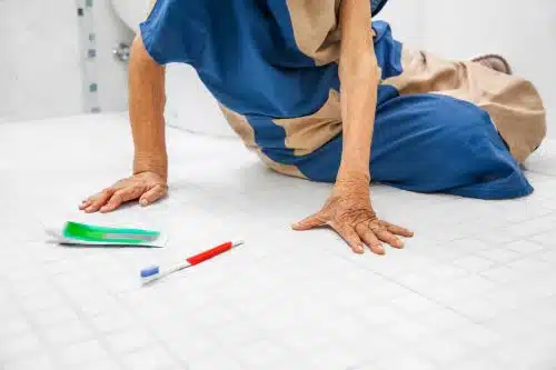 An elderly woman has a slip and fall accident in her bathroom.