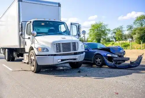A white commercial truck collides with a blue vehicle on a Raleigh highway.
